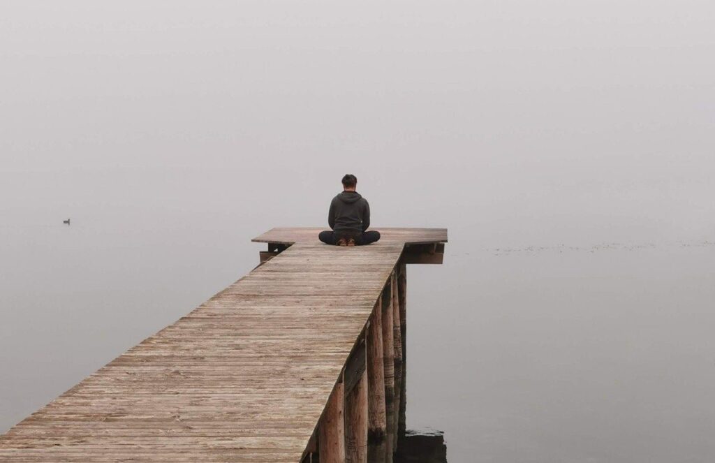 man on lake dock